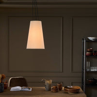 Jet Black pendant light hanging elegantly over a wooden dining table setting.