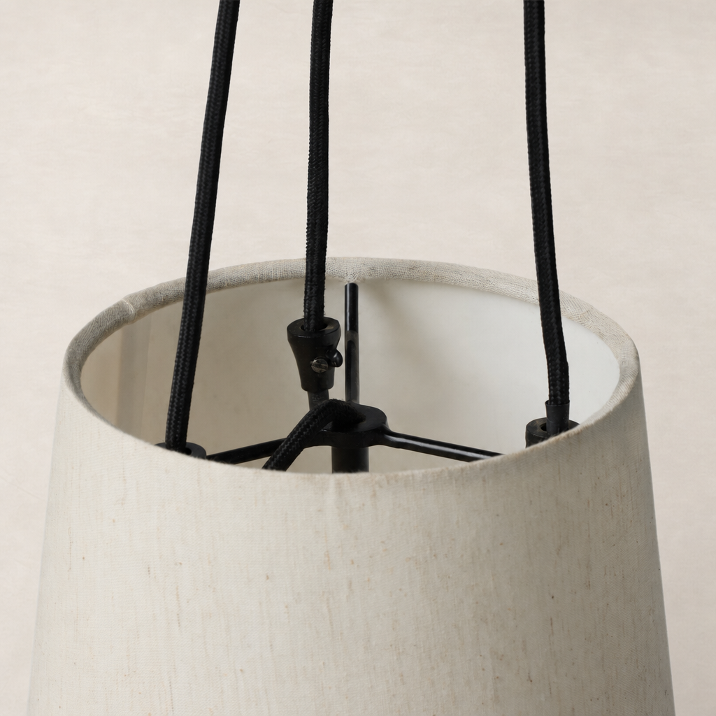 Jet black pendant light featuring an elegant fabric shade and minimalist design.