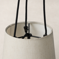 Jet black pendant light featuring an elegant fabric shade and minimalist design.