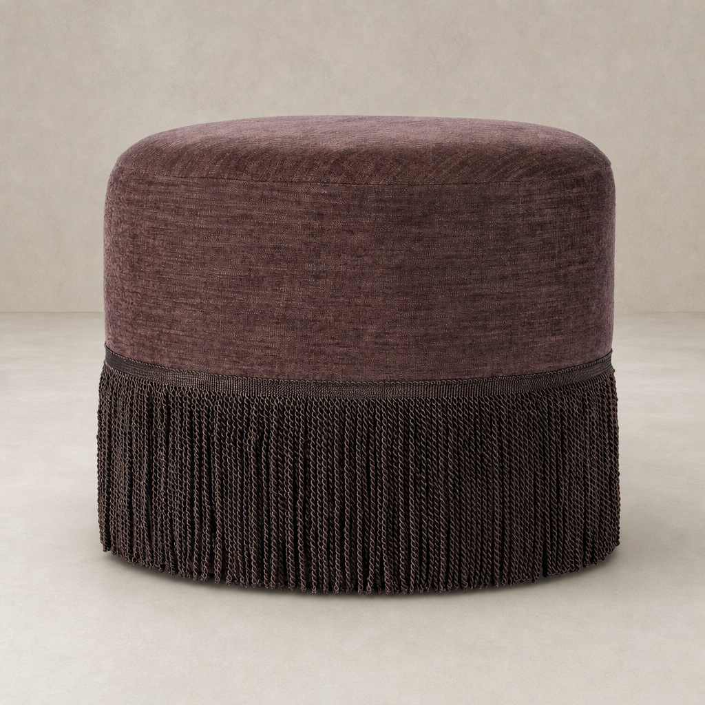 Fringe ottoman in Laughlin Plum with stylish fringe detailing and soft, textured upholstery.