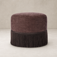 Round fringe ottoman in Laughlin Plum with textured fabric and elegant trim.