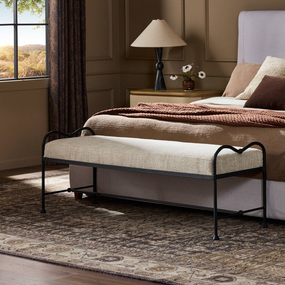 Side view of the Rune Accent Bench featuring a plush cream seat and elegant black metal frame.