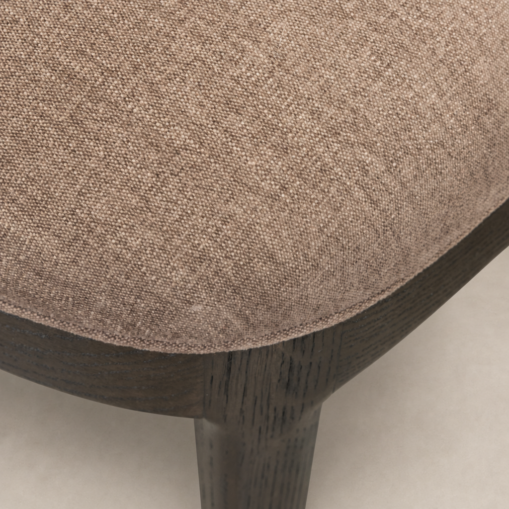 Close-up of the Hawthorne Dining Chair in Laughlin Cafe fabric, showcasing textured upholstery and sturdy wooden legs.