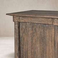 Lisbon Cabinet in distressed cocoa pine, showcasing textured wood grain and sharp edges.