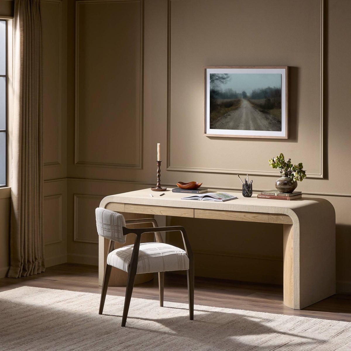 Kyoto Desk in sandy oak with curved design appeals in elegant room setting.