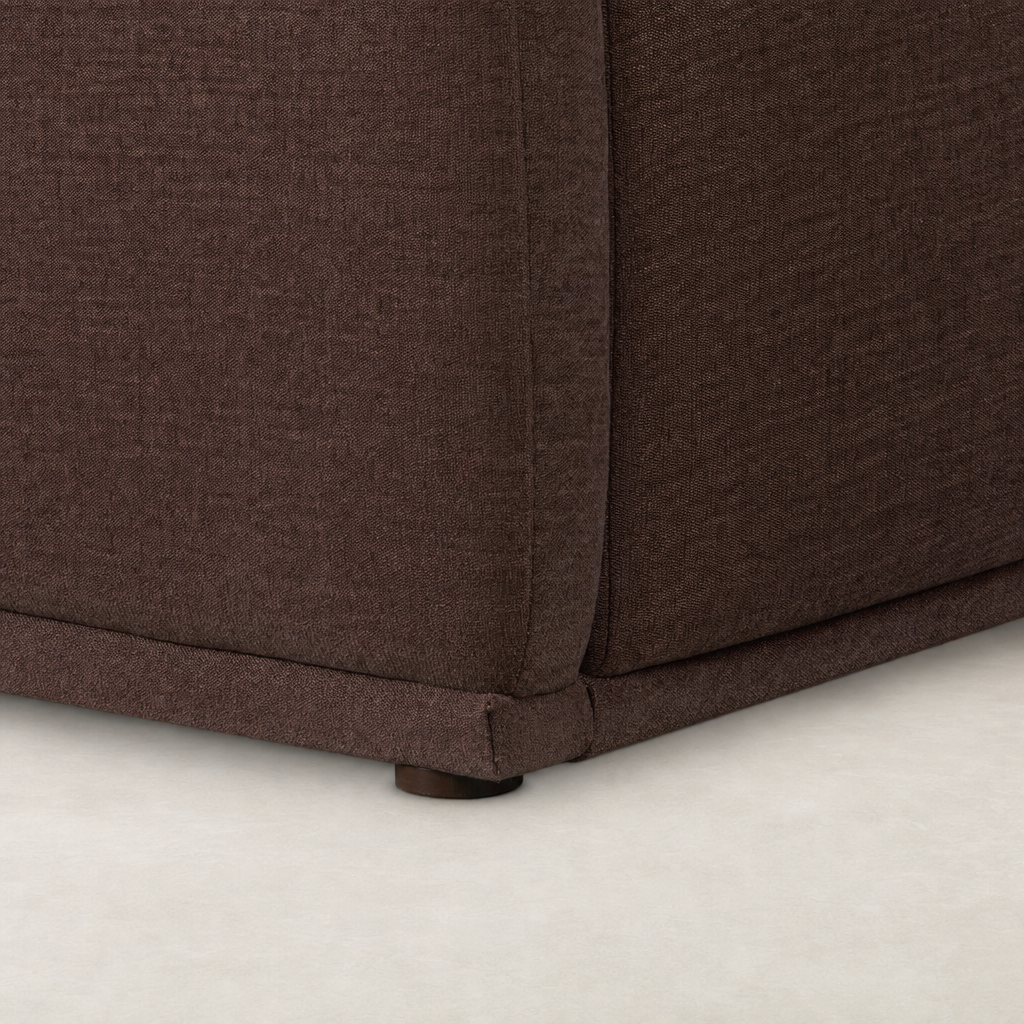 Close-up of Laughlin Plum bed’s upholstered fabric and sturdy base.