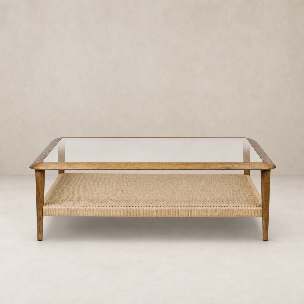Brandy Coffee Table featuring tempered glass top and natural woven shelf in a modern design.
