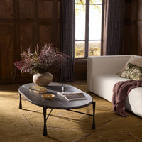 Rhea Coffee Table with grey Italian marble top and elegant black legs in a cozy living room.