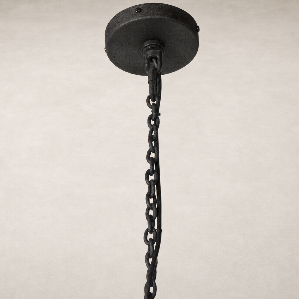 Black chain pendant light fixture with round ceiling mount design.