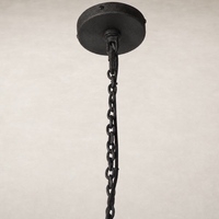 Black chain pendant light fixture with round ceiling mount design.