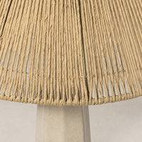 Cream marble table lamp with a woven natural fiber shade.