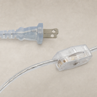 Transparent cord and plug details of a cream Italian marble table lamp.