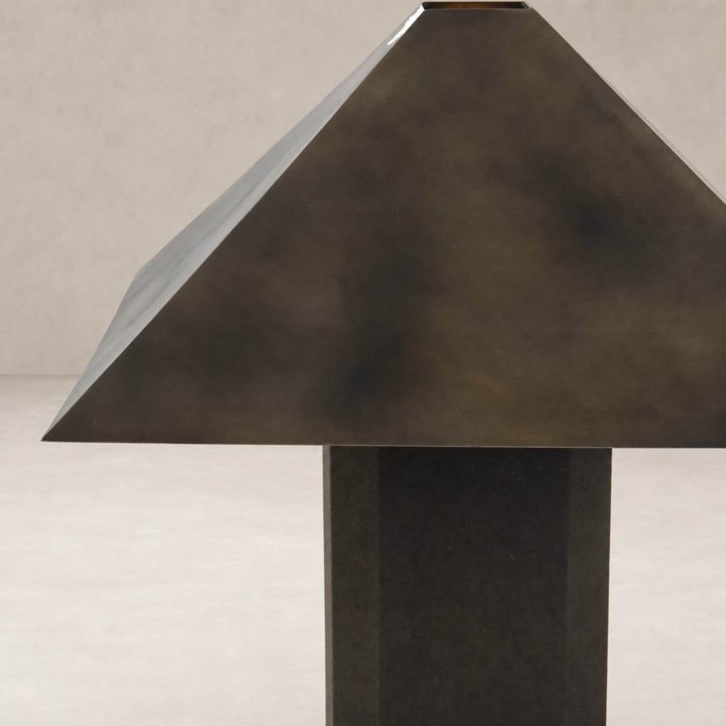 Forest green canvas table lamp with a geometric, pyramid-shaped shade.