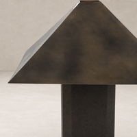Forest green canvas table lamp with a geometric, pyramid-shaped shade.