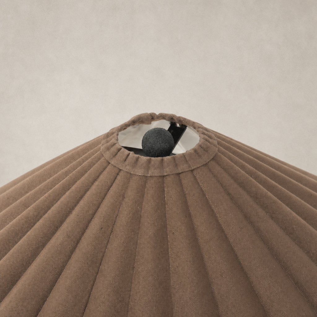 Espresso canvas table lamp featuring a pleated shade and decorative top.