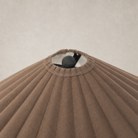 Espresso canvas table lamp featuring a pleated shade and decorative top.
