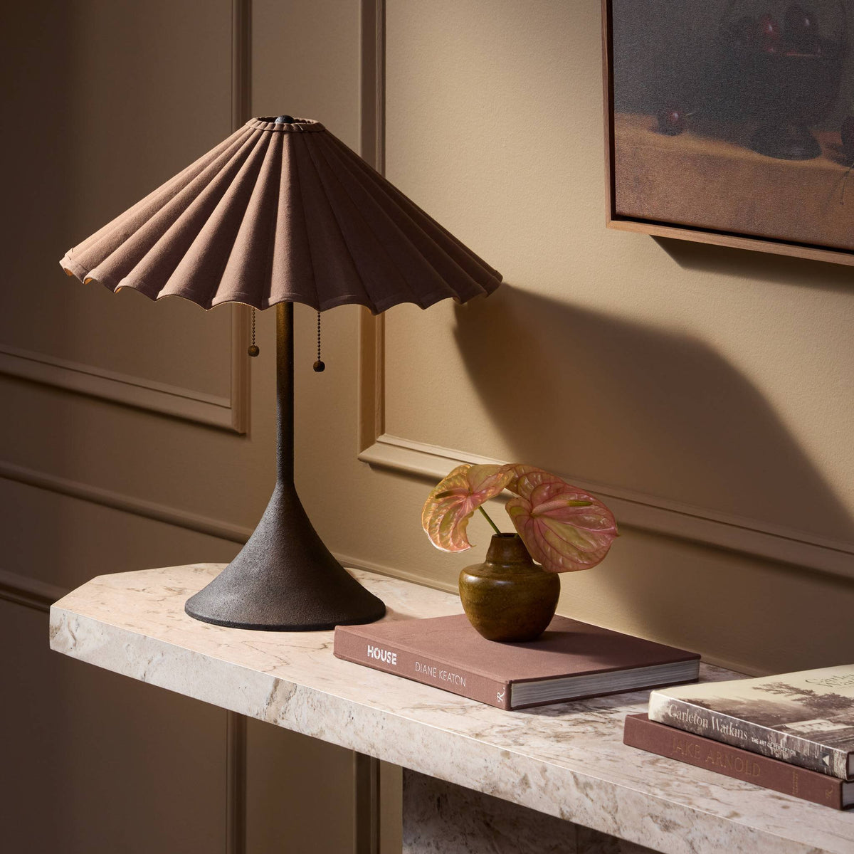 Espresso canvas table lamp with a pleated shade on a stylish marble surface.