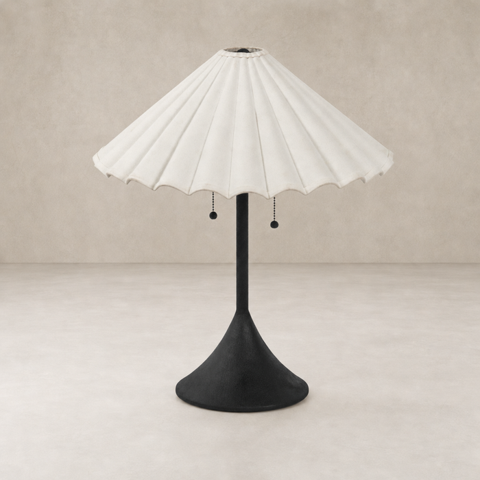 Cream canvas table lamp with a fluted shade and black base.
