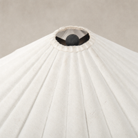 Cream canvas table lamp with pleated shade and central decorative sphere.