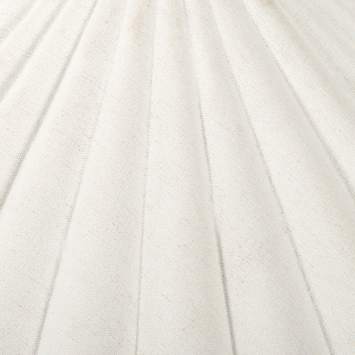 Cream canvas table lamp showcasing a textured, pleated shade design.