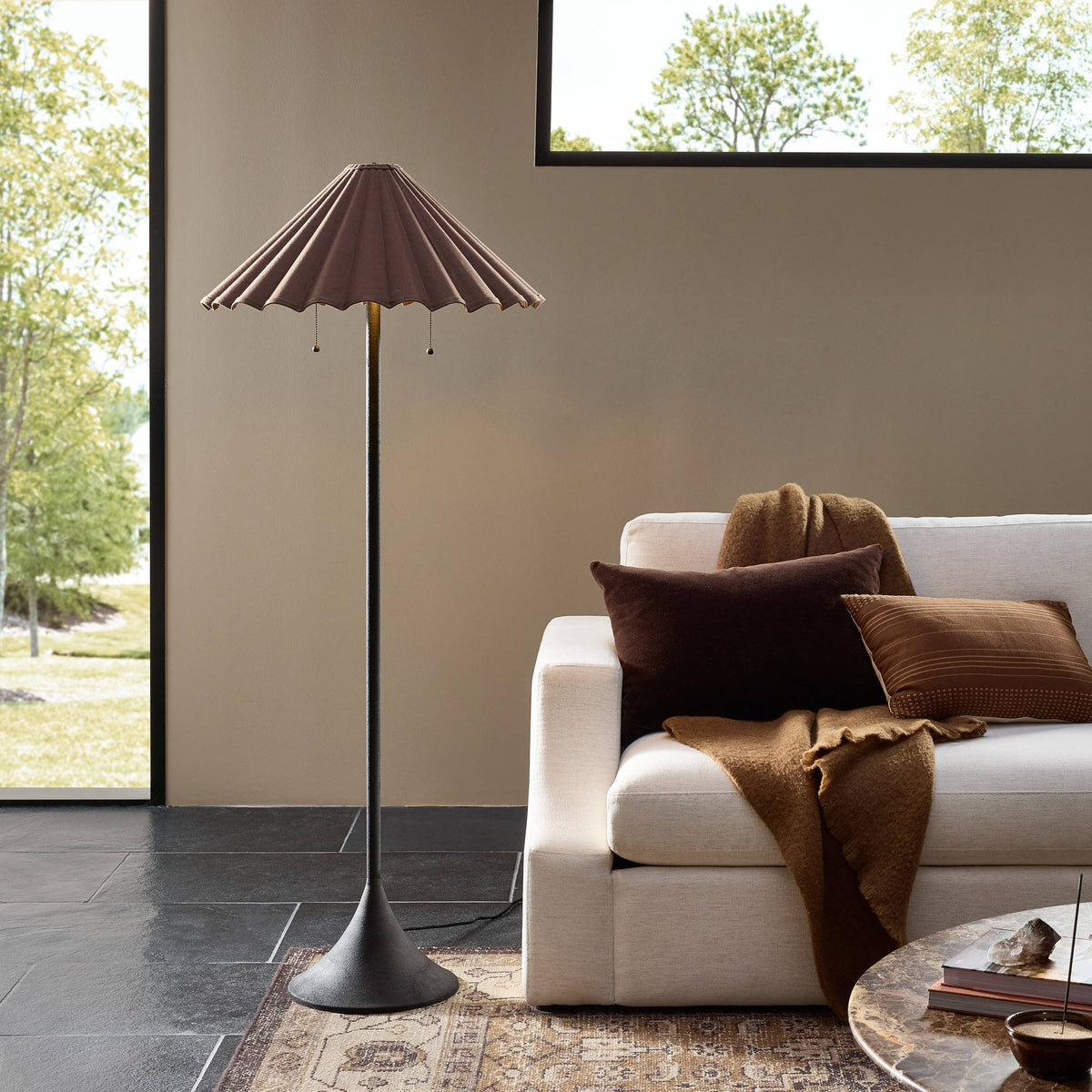 Espresso canvas floor lamp with a pleated shade in a cozy living room setting.