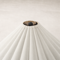 Cream canvas floor lamp featuring a pleated shade and central black finial.