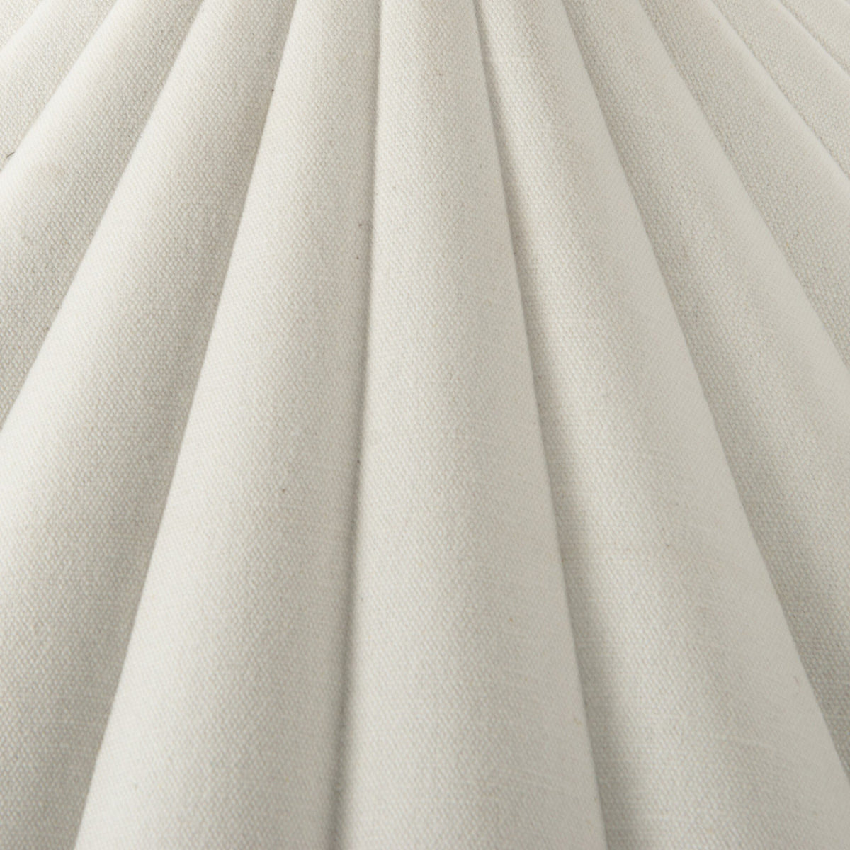 Close-up of cream canvas texture featuring pleated design for floor lamp.