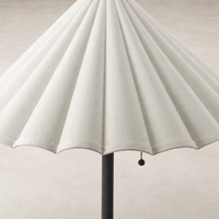 Cream canvas floor lamp with a scalloped shade design and black pull chain.