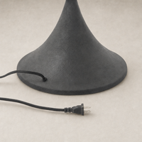 Cream canvas floor lamp with a sleek, bell-shaped black base and power cord.