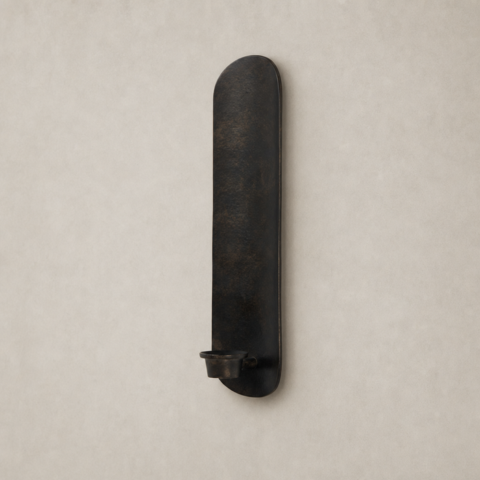 Zola Wall Mounted Candle Holder in distressed bronze with sleek, elongated design and candle cup.