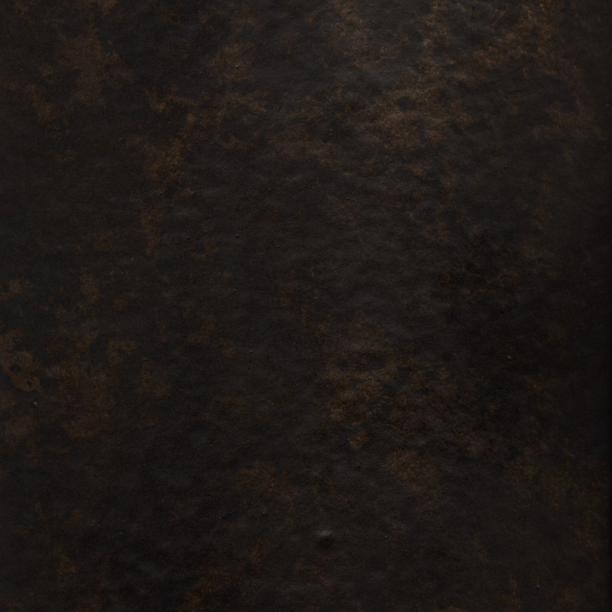 Distressed bronze texture close-up of Zola wall mounted candle holder.