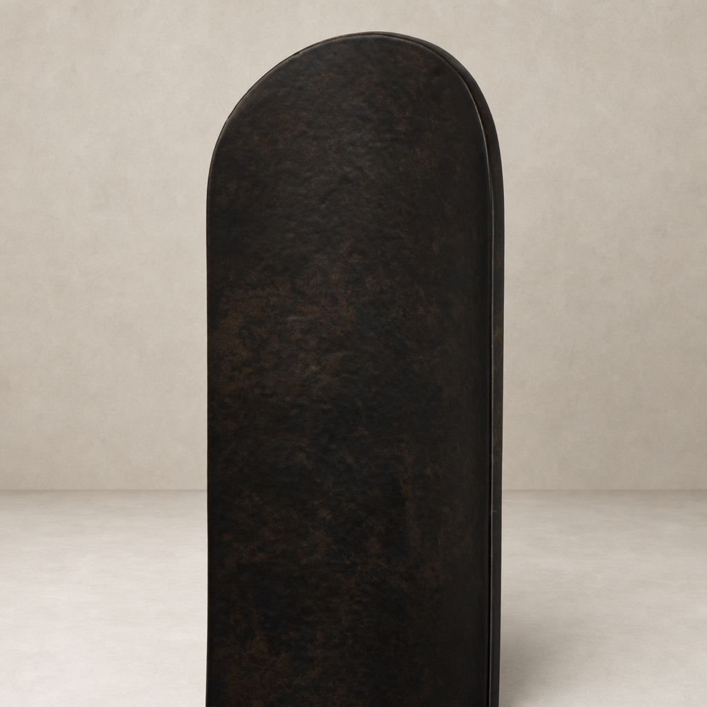 Zola Wall Mounted Candle Holder set in distressed bronze with a sleek rounded design.