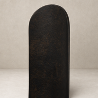 Zola Wall Mounted Candle Holder set in distressed bronze with a sleek rounded design.