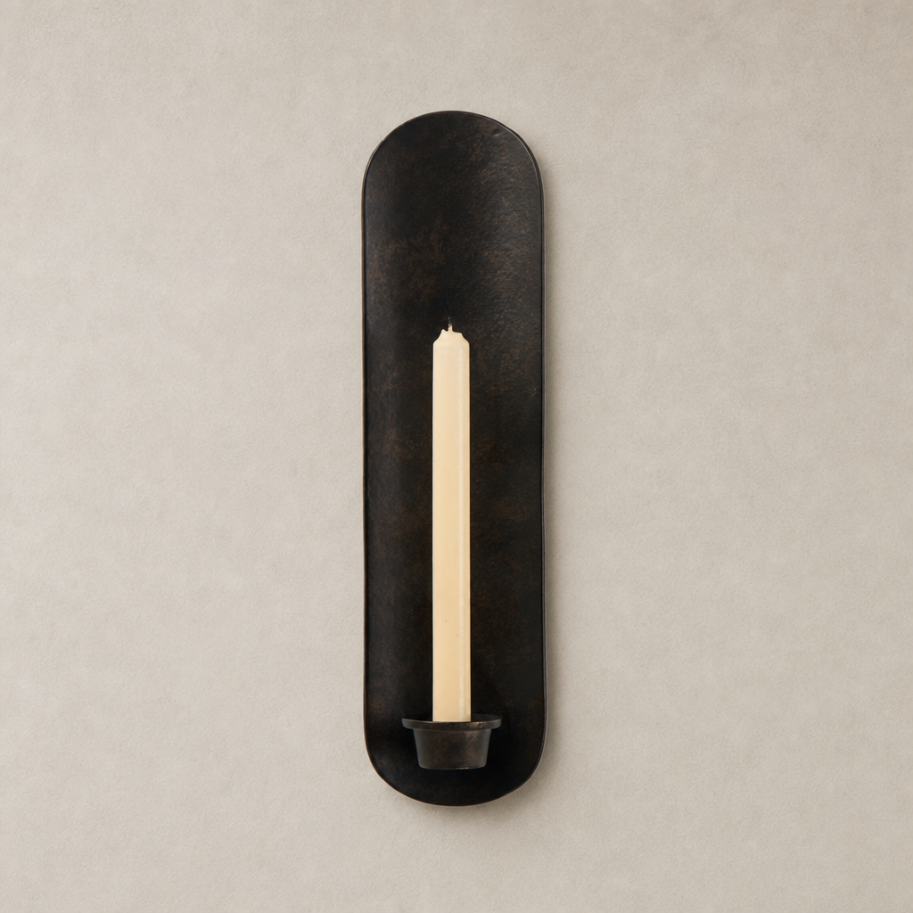 Zola Wall Mounted Candle Holder in distressed bronze, featuring a sleek oval design and holder for taper candles.