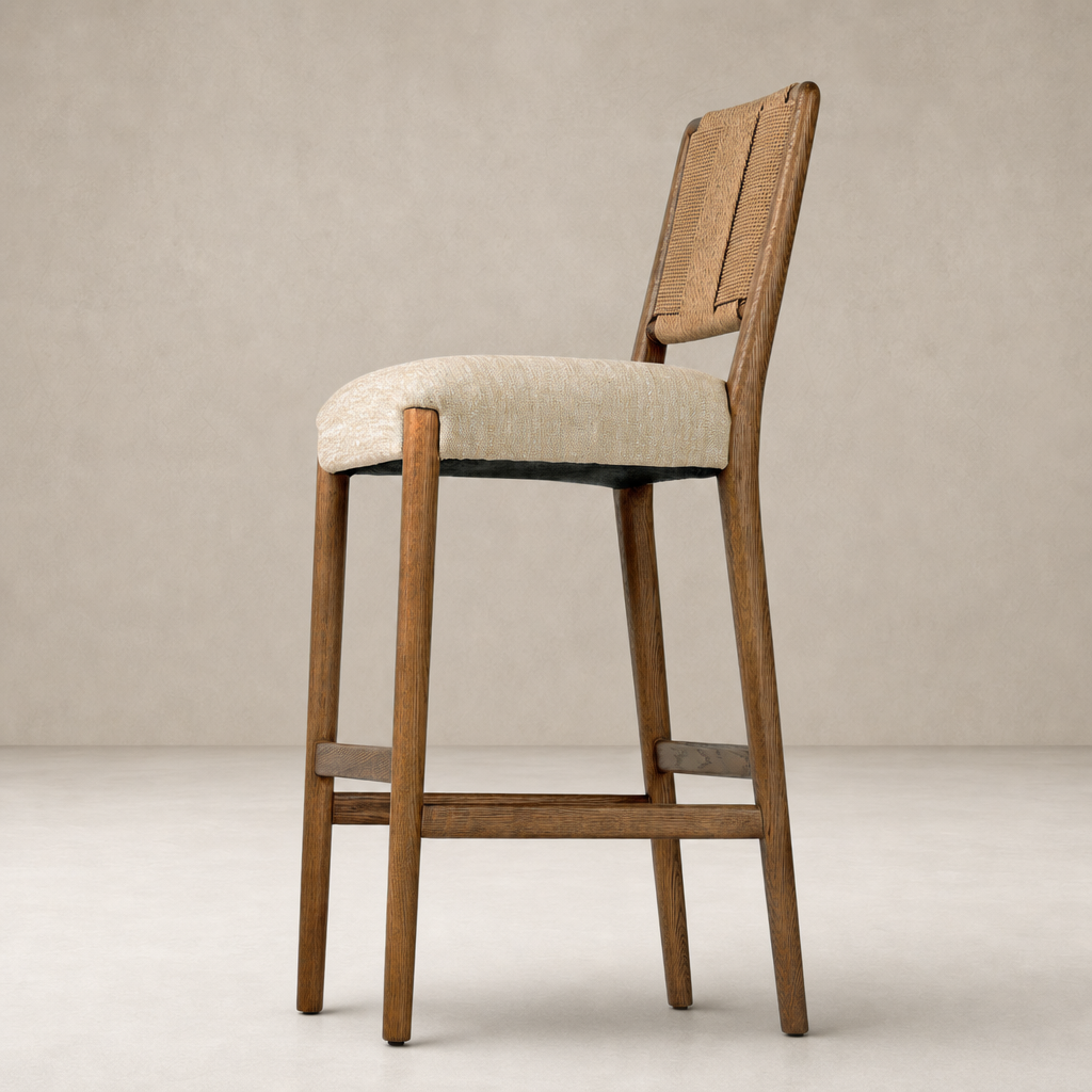 Kauri Bar + Counter Stool in Alcala Wheat, featuring a textured fabric seat and natural wood frame.