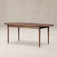 Cortina Oval Extension Dining Table in toasted walnut with elegant rounded edges.