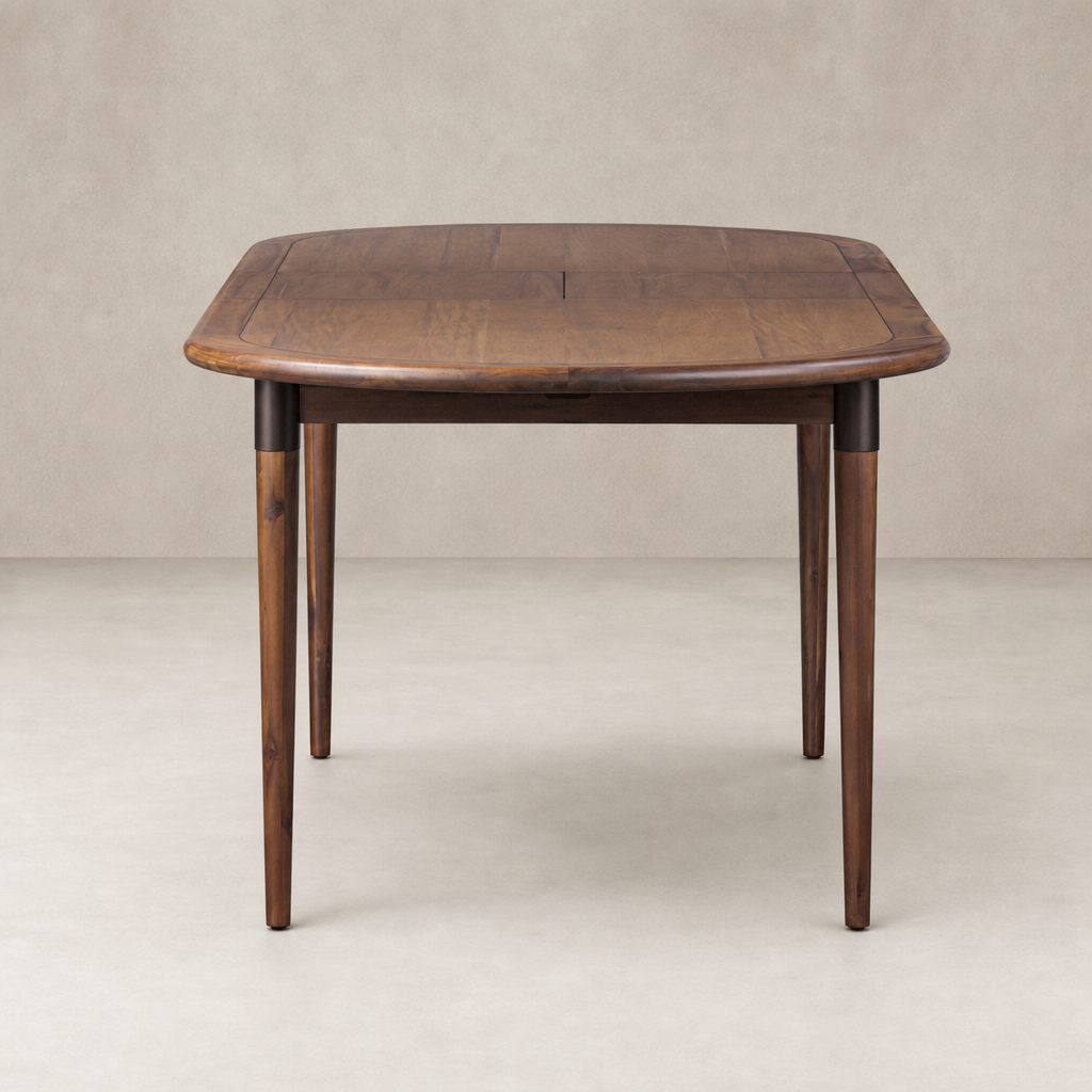 Cortina Oval Extension Dining Table in Toasted Walnut with smooth, round edges and tapered legs.