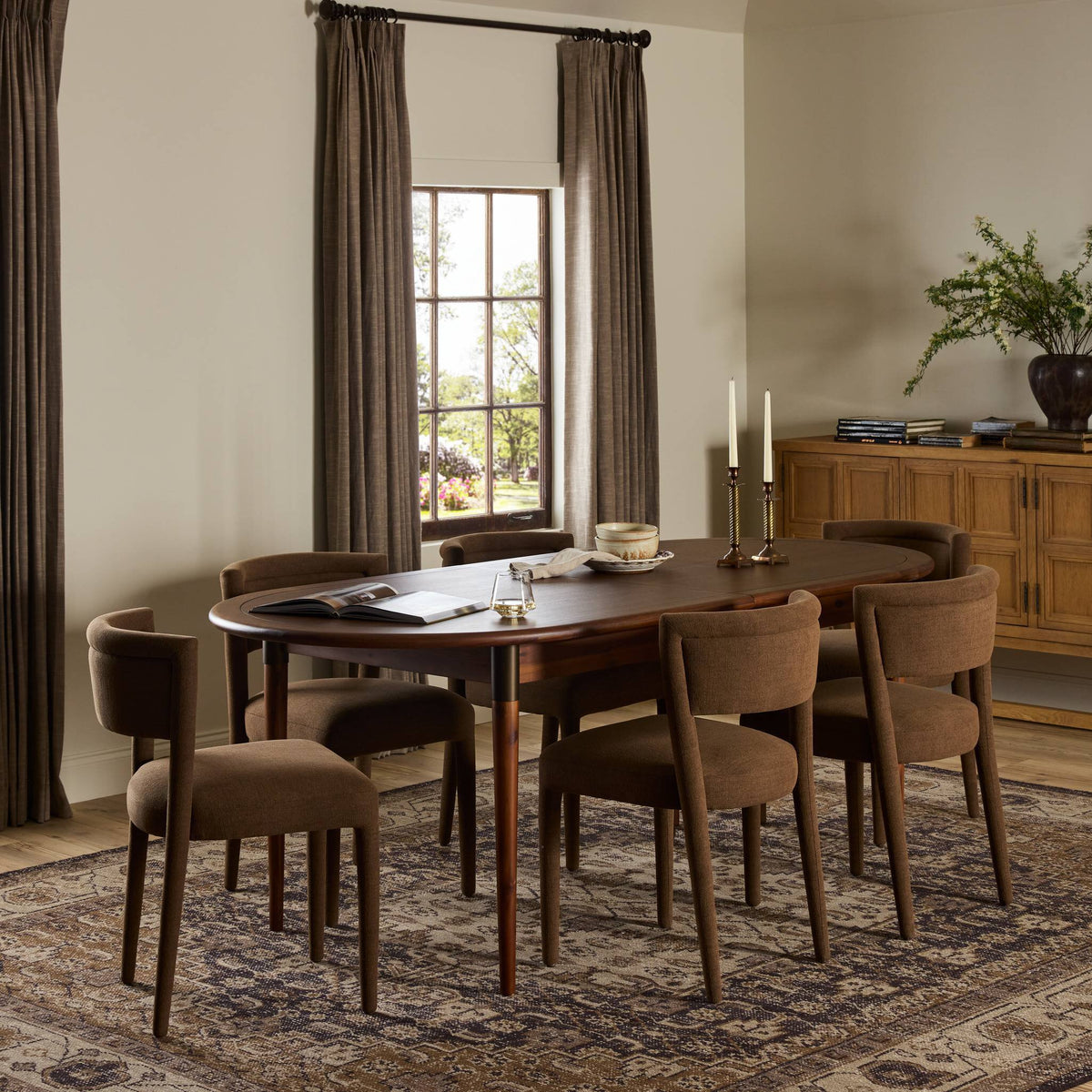 Cortina Oval Extension Dining Table in toasted walnut with elegant, curved edges and rich finish.