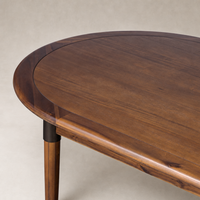 Cortina Oval Extension Dining Table in toasted walnut featuring smooth, rounded edges and elegant detailing.