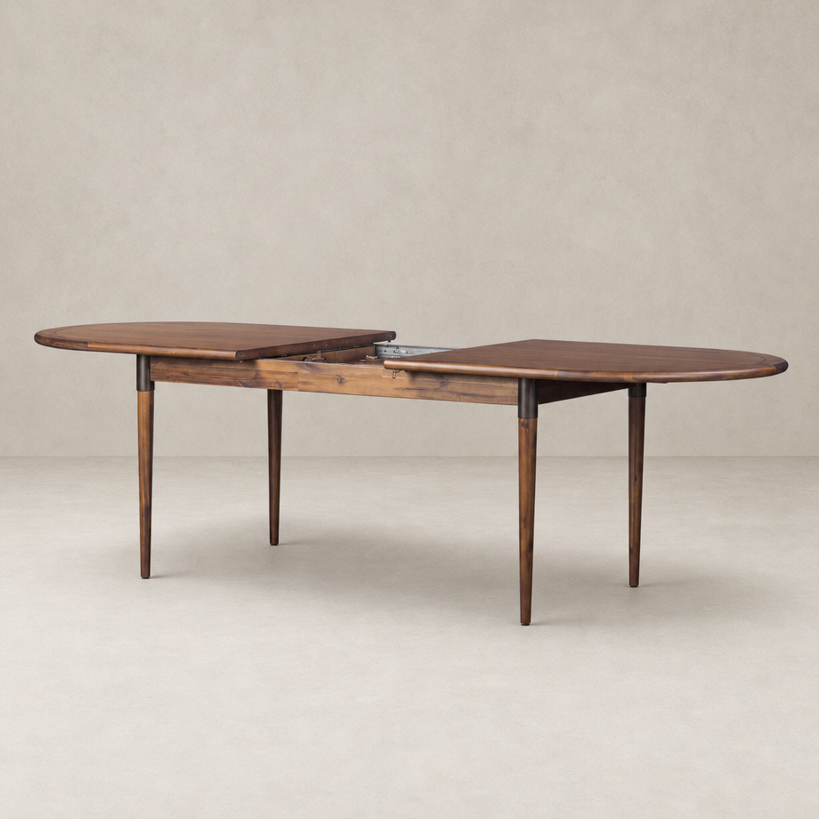 Cortina Oval Extension Dining Table in toasted walnut with elegant curved edges.