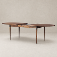 Cortina Oval Extension Dining Table in toasted walnut with elegant curved edges.