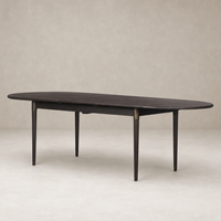 Cortina Oval Extension Dining Table in black mango, featuring sleek oval shape and tapered legs.