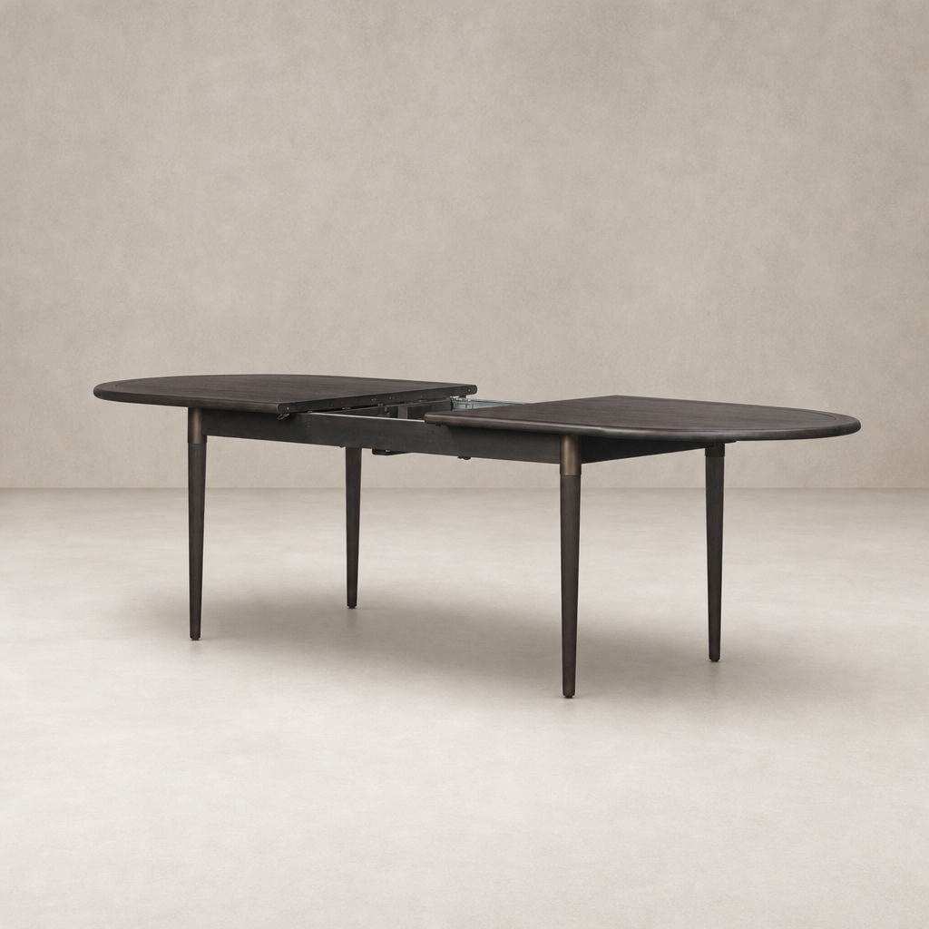 Cortina Oval Extension Dining Table in black mango with sleek rounded edges and elegant legs.