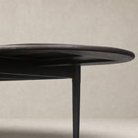 Cortina Oval Extension Dining Table in black mango with sleek, modern design and tapered legs.