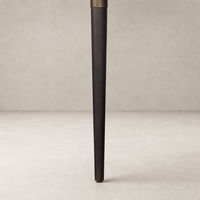 Cortina Oval Extension Dining Table featuring a sleek black mango wood leg.