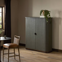 Kanoa Cabinet in dark green lacquered linen with sleek doors and a minimalist design.