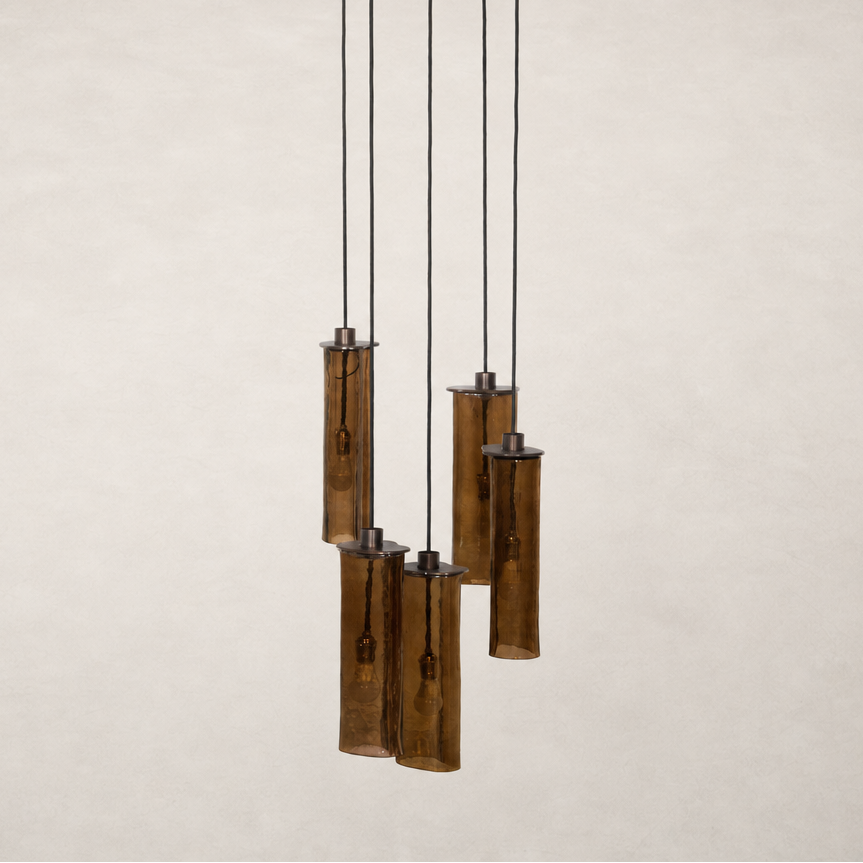 Chandelier with five textured glass tubes and black suspension cables.