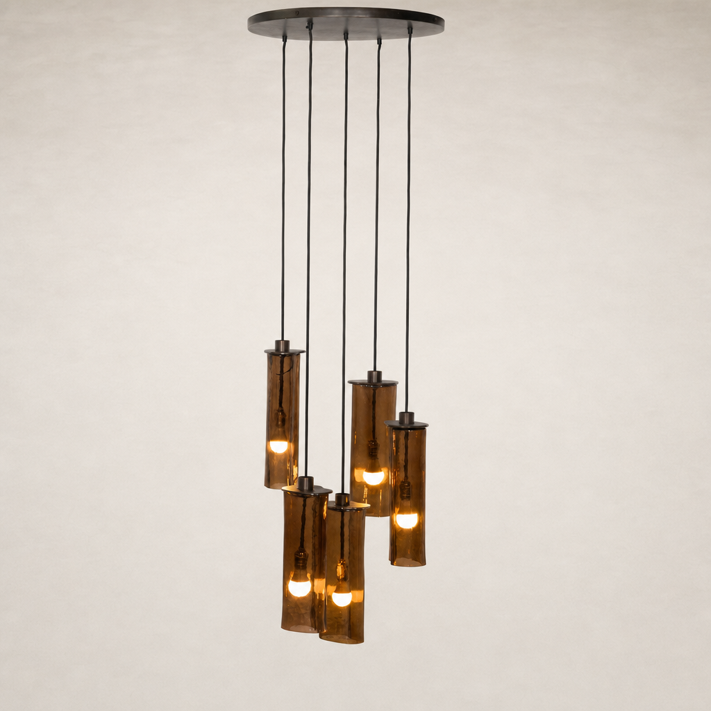 Chandelier with cylindrical glass shades and warm light bulbs.
