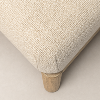 Close-up of the Skye Dining Chair in Irving Flax, highlighting its textured fabric and wooden legs.