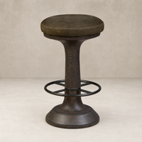 Nubuck olive counter stool with a round padded seat and wooden pedestal base.